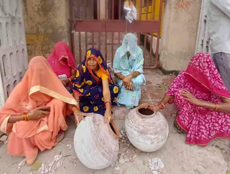 In Khemli, Udaipur, women broke pots outside the Panchayat Bhawan