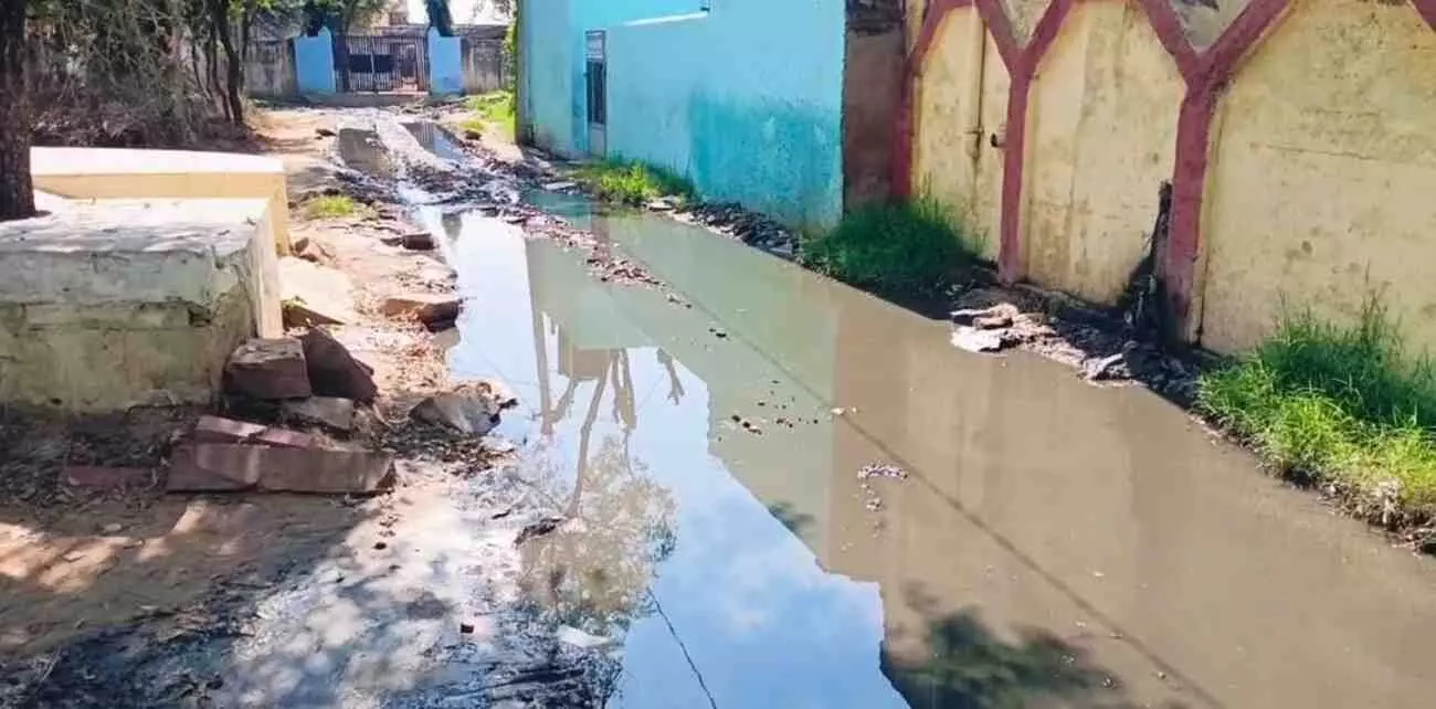नगला कल्याण गांव के मुख्य रास्ते पर जमा गंदा पानी और कीचड़ जिसे ग्रामीण पार कर रहे हैं। नगला कल्याण गांव के मुख्य रास्ते पर जमा गंदा पानी और कीचड़ जिसे ग्रामीण पार कर रहे हैं।