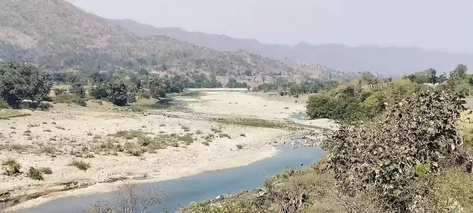 उदयपुर के फलासिया में अरावली पर्वतमाला के बीच बहती वांकल नदी और घने वन क्षेत्र का विहंगम दृश्य। उदयपुर के फलासिया में अरावली पर्वतमाला के बीच बहती वांकल नदी और घने वन क्षेत्र का विहंगम दृश्य।