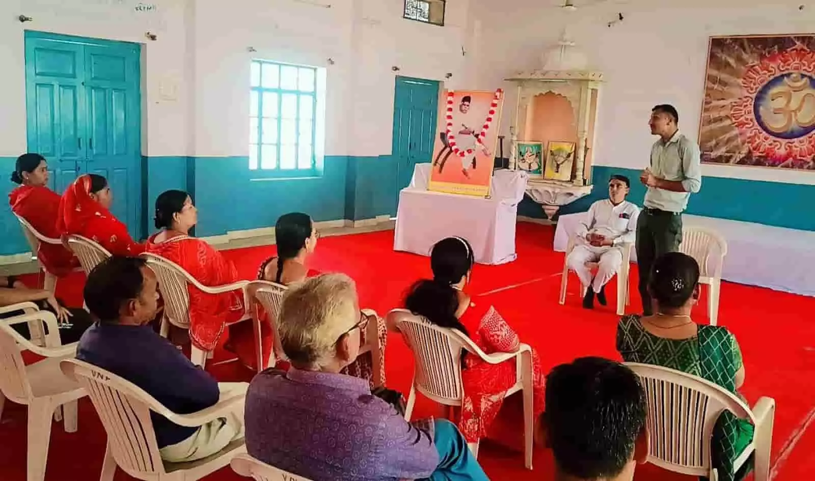 विद्यानिकेतन फतहनगर में डॉ. हेडगेवार की तस्वीर के सामने दीप प्रज्वलन करते अतिथि और उपस्थित विद्यार्थी समूह।