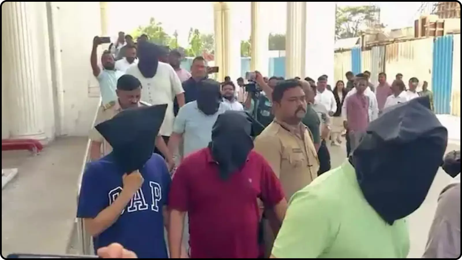 पुलिसकर्मियों के साथ चेहरा ढंककर चलते हुए आरोपी नासिक में यौन उत्पीड़न मामले की जांच के दौरान।