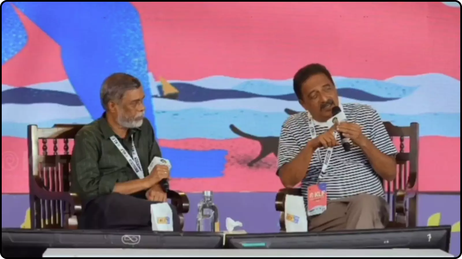 मंच पर बैठे हुए अभिनेता प्रकाश राज हाथ में माइक्रोफोन लेकर दर्शकों को संबोधित करते हुए दिखाई दे रहे हैं। मंच पर बैठे हुए अभिनेता प्रकाश राज हाथ में माइक्रोफोन लेकर दर्शकों को संबोधित करते हुए दिखाई दे रहे हैं।