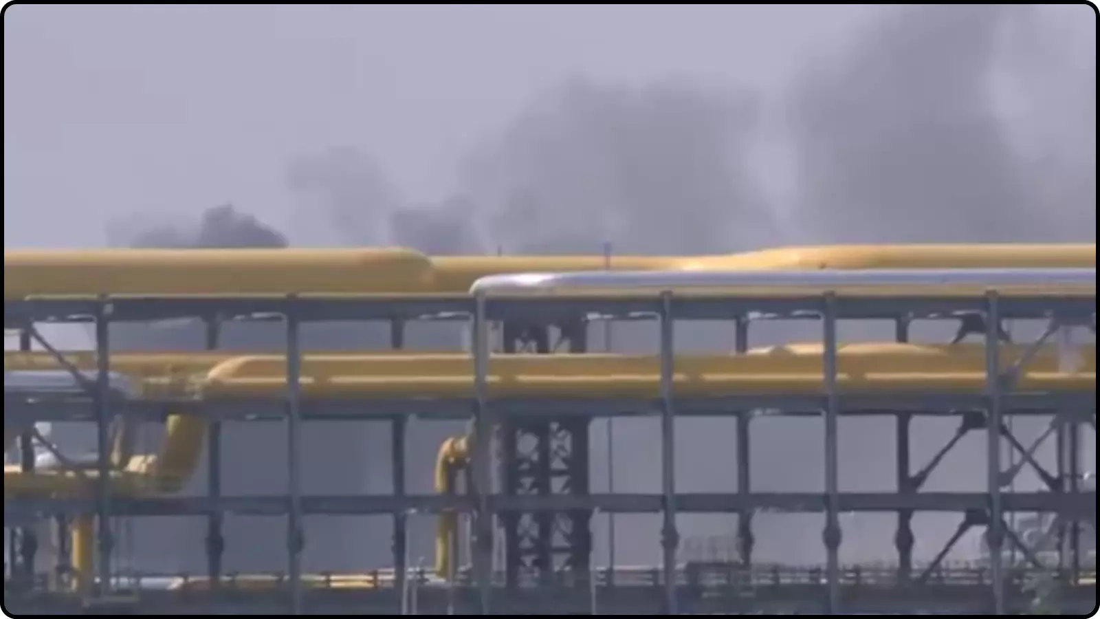 औद्योगिक पाइपलाइन और ढांचे के पीछे से उठता गहरा धुआं पचपदरा रिफाइनरी में आग लगने के संदर्भ में दिख रहा है।