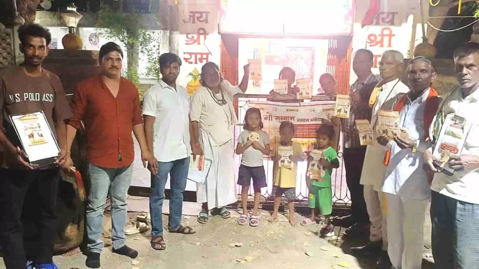 भीलवाड़ा के मंदिर परिसर में गौ रक्षा अभियान के पोस्टर पकड़े हुए स्थानीय नागरिकों और बच्चों का समूह। भीलवाड़ा के मंदिर परिसर में गौ रक्षा अभियान के पोस्टर पकड़े हुए स्थानीय नागरिकों और बच्चों का समूह।
