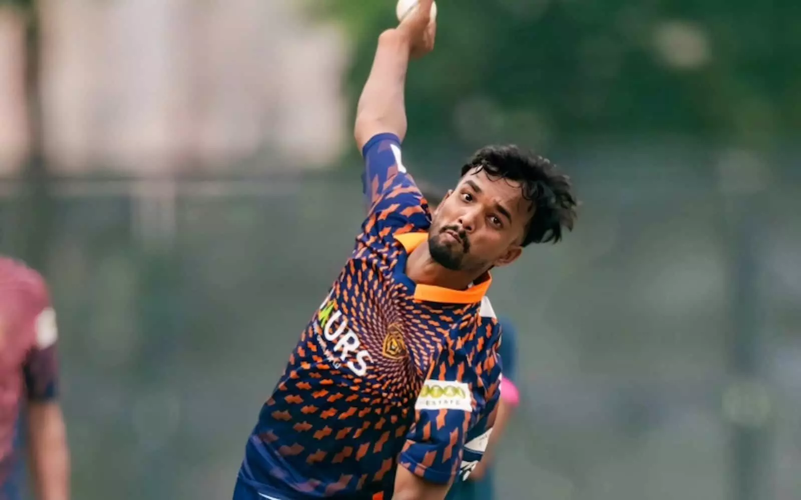 नीली और नारंगी जर्सी में क्रिकेट खिलाड़ी विशाल निशाद मैदान पर गेंदबाजी एक्शन के दौरान गेंद रिलीज करते हुए। नीली और नारंगी जर्सी में क्रिकेट खिलाड़ी विशाल निशाद मैदान पर गेंदबाजी एक्शन के दौरान गेंद रिलीज करते हुए।