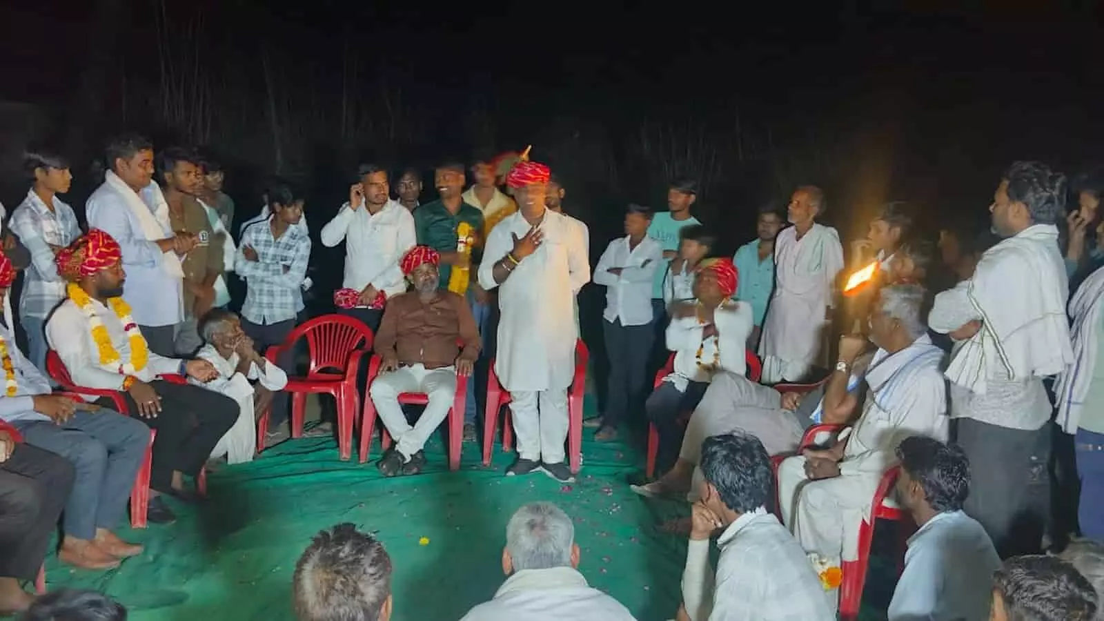 रात के समय एक बैठक में खड़े होकर संबोधन देते हुए राम अवतार मीणा और उपस्थित अन्य लोग। रात के समय एक बैठक में खड़े होकर संबोधन देते हुए राम अवतार मीणा और उपस्थित अन्य लोग।