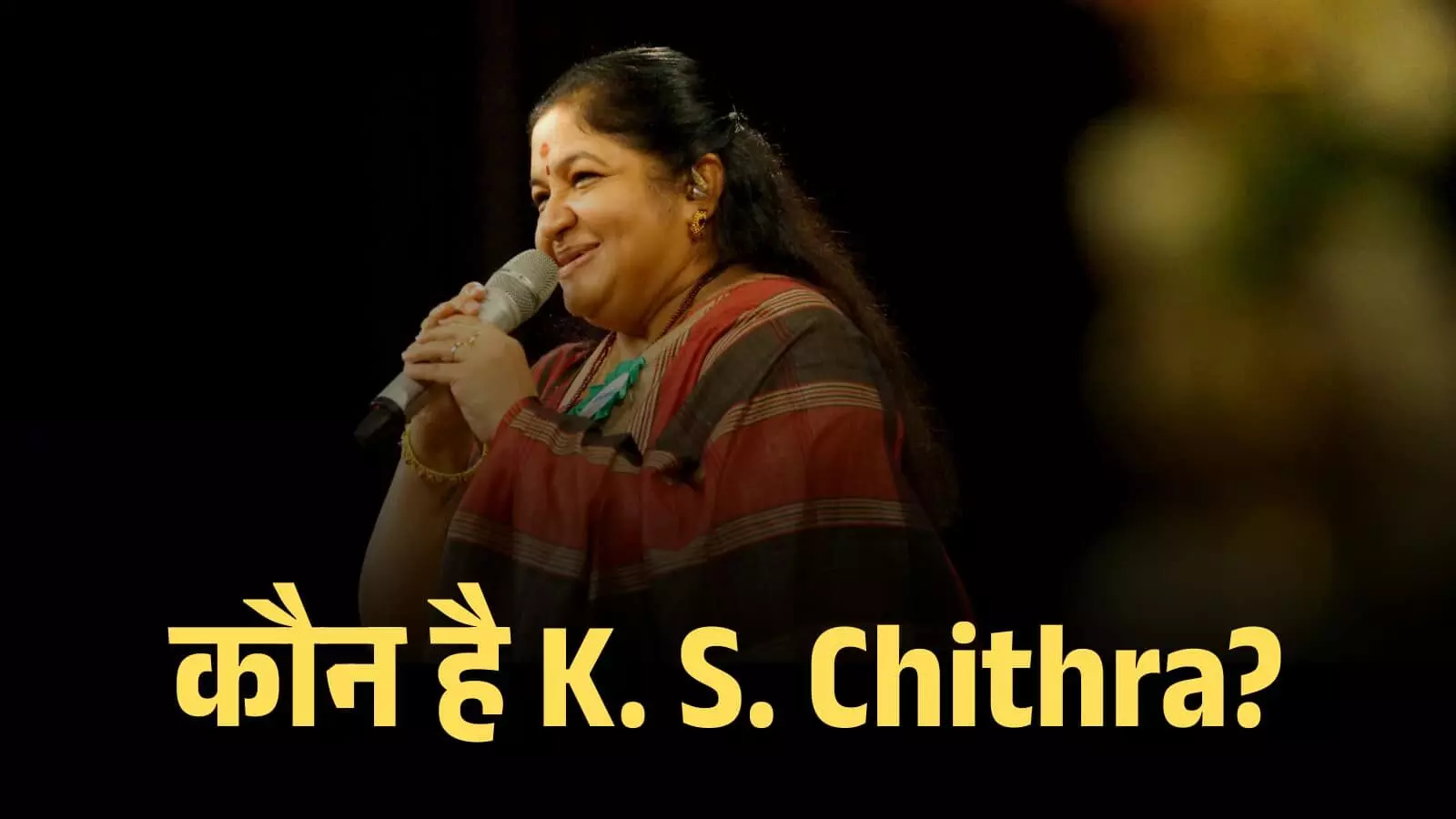 स्टेज पर माइक के साथ मुस्कुराती हुई गायिका के. एस. चित्रा संगीत कार्यक्रम में प्रस्तुति दे रही हैं। स्टेज पर माइक के साथ मुस्कुराती हुई गायिका के. एस. चित्रा संगीत कार्यक्रम में प्रस्तुति दे रही हैं।