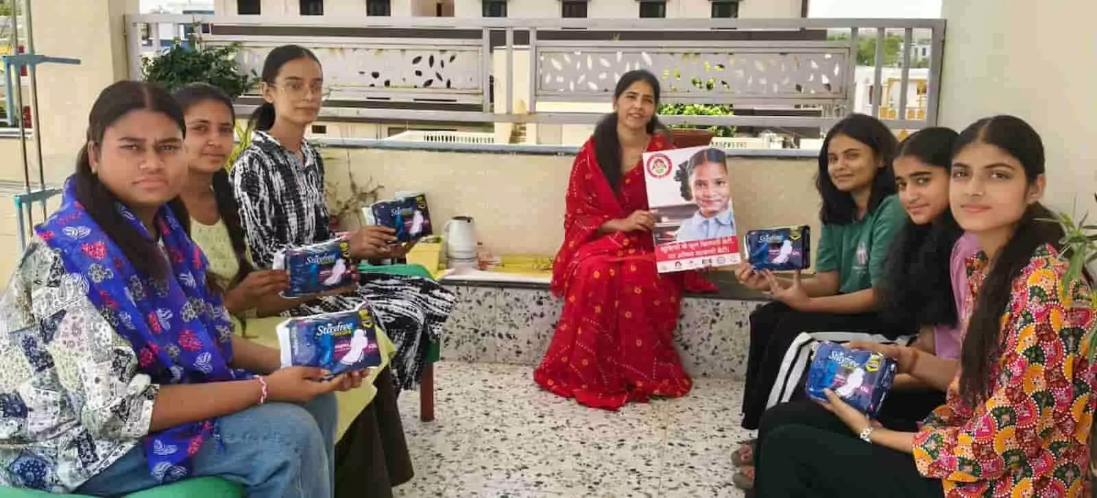 भावना पालीवाल युवतियों को सेनेटरी पैड और जागरूकता पोस्टर दिखाते हुए छत पर चर्चा कर रही हैं। भावना पालीवाल युवतियों को सेनेटरी पैड और जागरूकता पोस्टर दिखाते हुए छत पर चर्चा कर रही हैं।