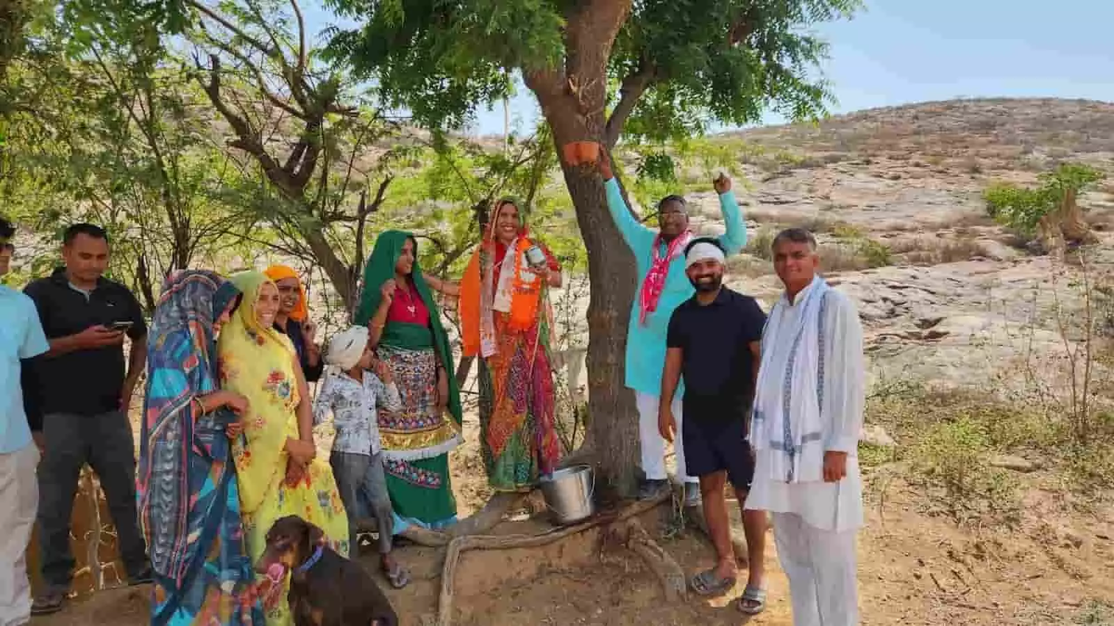बयाना के पहाड़ी क्षेत्र में पेड़ पर पानी का परिंडा बांधतीं पूर्व सांसद रंजिता कोली और कार्यकर्ता।
