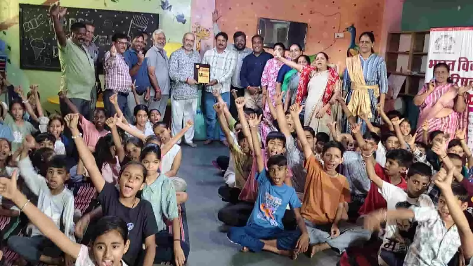 गायत्री नगर के कूडोज़ किड्स स्कूल में भारत विकास परिषद के बाल संस्कार शिविर में हाथ उठाकर उत्साह मनाते बच्चे और अतिथि।