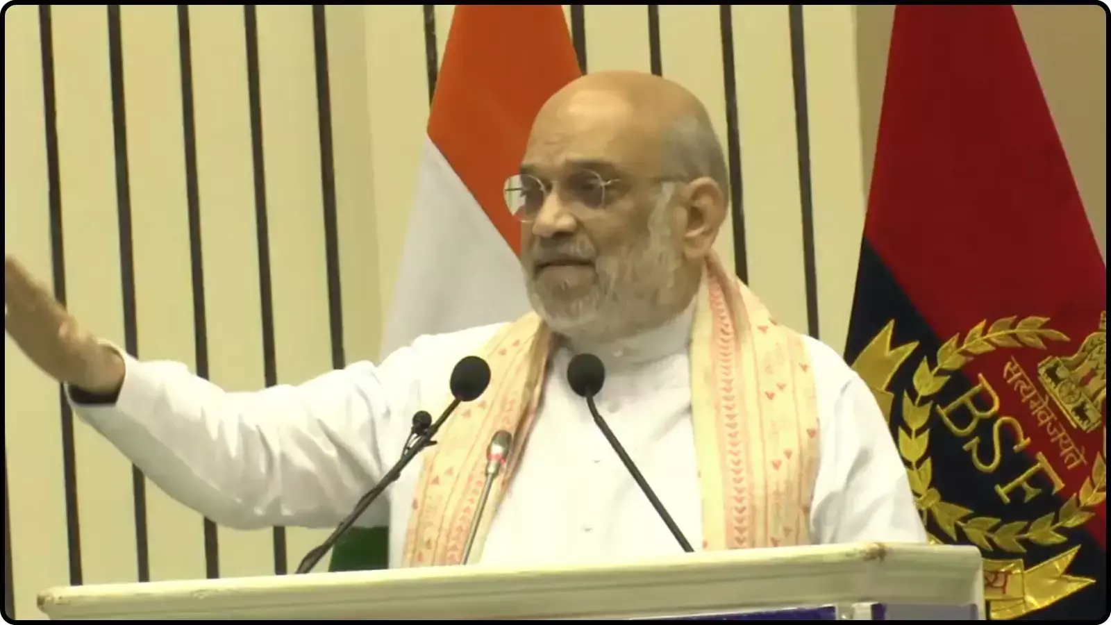 मंच पर पोडियम के पीछे खड़े होकर हाथ के इशारे से भाषण देते हुए केंद्रीय गृह मंत्री अमित शाह। मंच पर पोडियम के पीछे खड़े होकर हाथ के इशारे से भाषण देते हुए केंद्रीय गृह मंत्री अमित शाह।