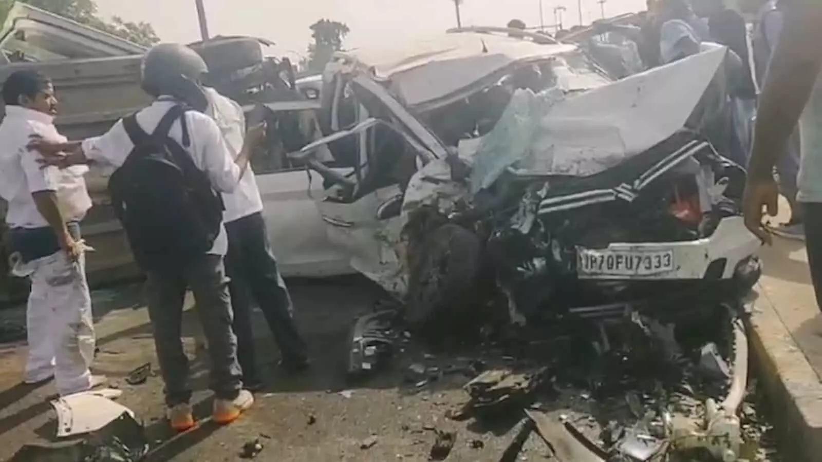 प्रयागराज के नैनी ब्रिज पर सड़क हादसे के बाद क्षतिग्रस्त सफेद कार के पास खड़े लोग। प्रयागराज के नैनी ब्रिज पर सड़क हादसे के बाद क्षतिग्रस्त सफेद कार के पास खड़े लोग।