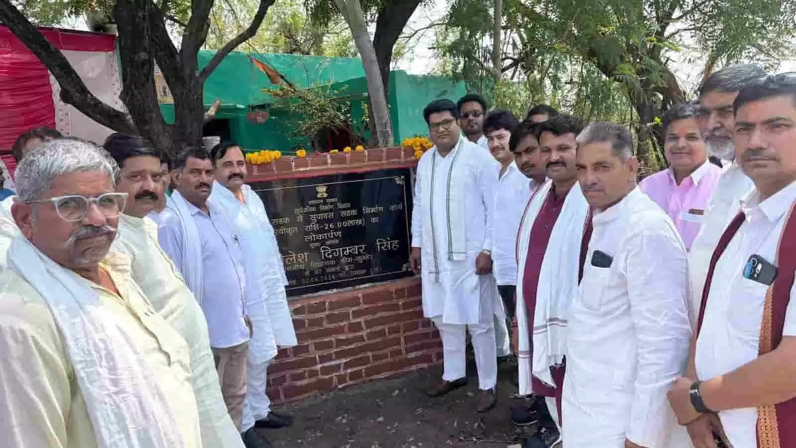 सड़क लोकार्पण पट्टिका के पास खड़े विधायक डॉ. शैलेष सिंह और ग्रामीण डीग-कुम्हेर में विकास कार्यों के उद्घाटन कार्यक्रम में।