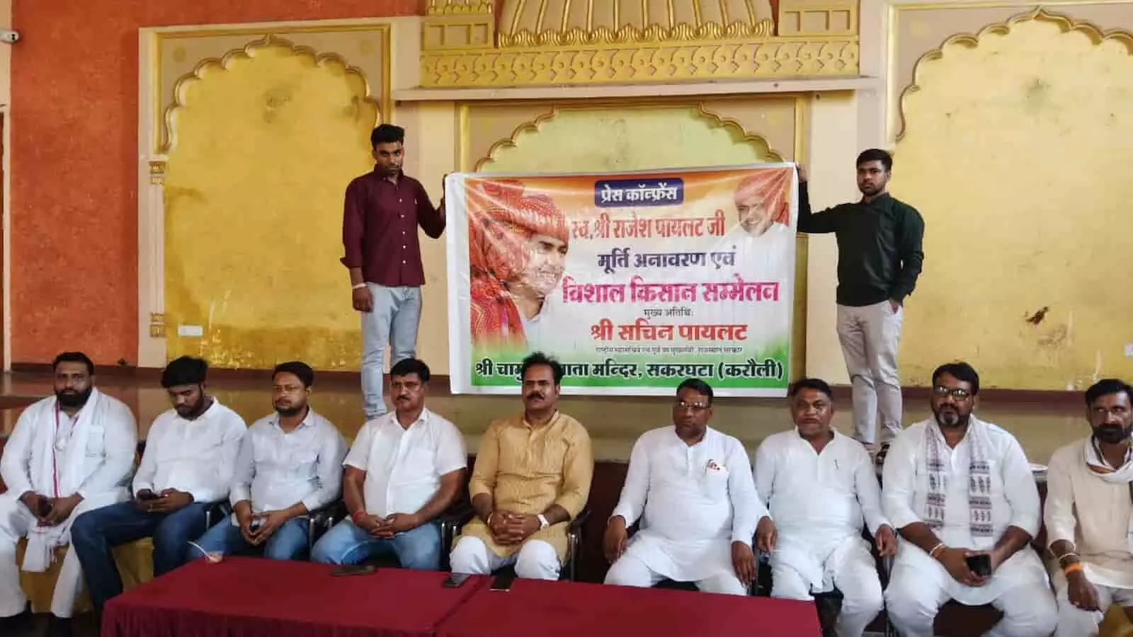हिंडौन में सचिन पायलट के सकरघटा दौरे के बैनर के साथ बैठे कांग्रेस पदाधिकारी प्रेस कॉन्फ्रेंस करते हुए।