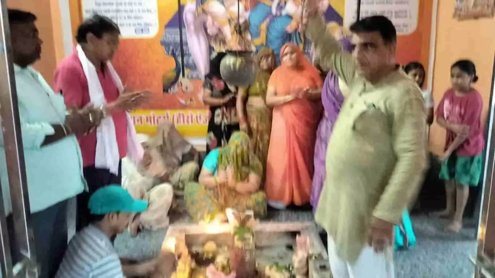 तस्वीर में एक छोटे मंदिर के गर्भगृह के सामने खड़े होकर पूजा-अर्चना करते लोग और पीछे बैठीं महिलाएं प्रधानमंत्री के कार्यकाल के उपलक्ष्य में आयोजित धार्मिक कार्यक्रम के संदर्भ में दिख रही हैं। तस्वीर में एक छोटे मंदिर के गर्भगृह के सामने खड़े होकर पूजा-अर्चना करते लोग और पीछे बैठीं महिलाएं प्रधानमंत्री के कार्यकाल के उपलक्ष्य में आयोजित धार्मिक कार्यक्रम के संदर्भ में दिख रही हैं।