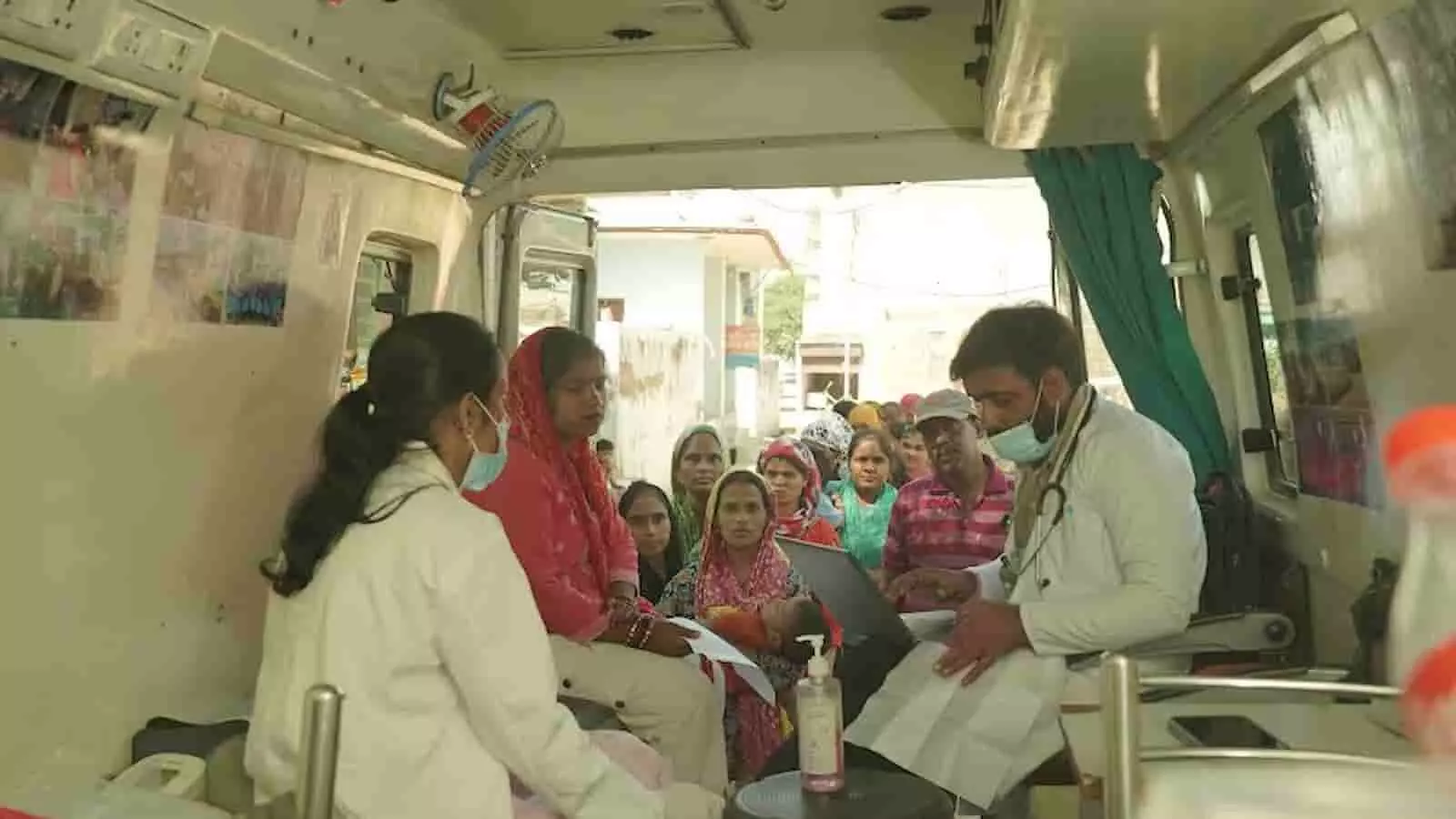 तस्वीर में स्माइल फाउंडेशन की वैन के पास स्वास्थ्य जांच के लिए कतारबद्ध ग्रामीण महिलाएं। तस्वीर में स्माइल फाउंडेशन की वैन के पास स्वास्थ्य जांच के लिए कतारबद्ध ग्रामीण महिलाएं।