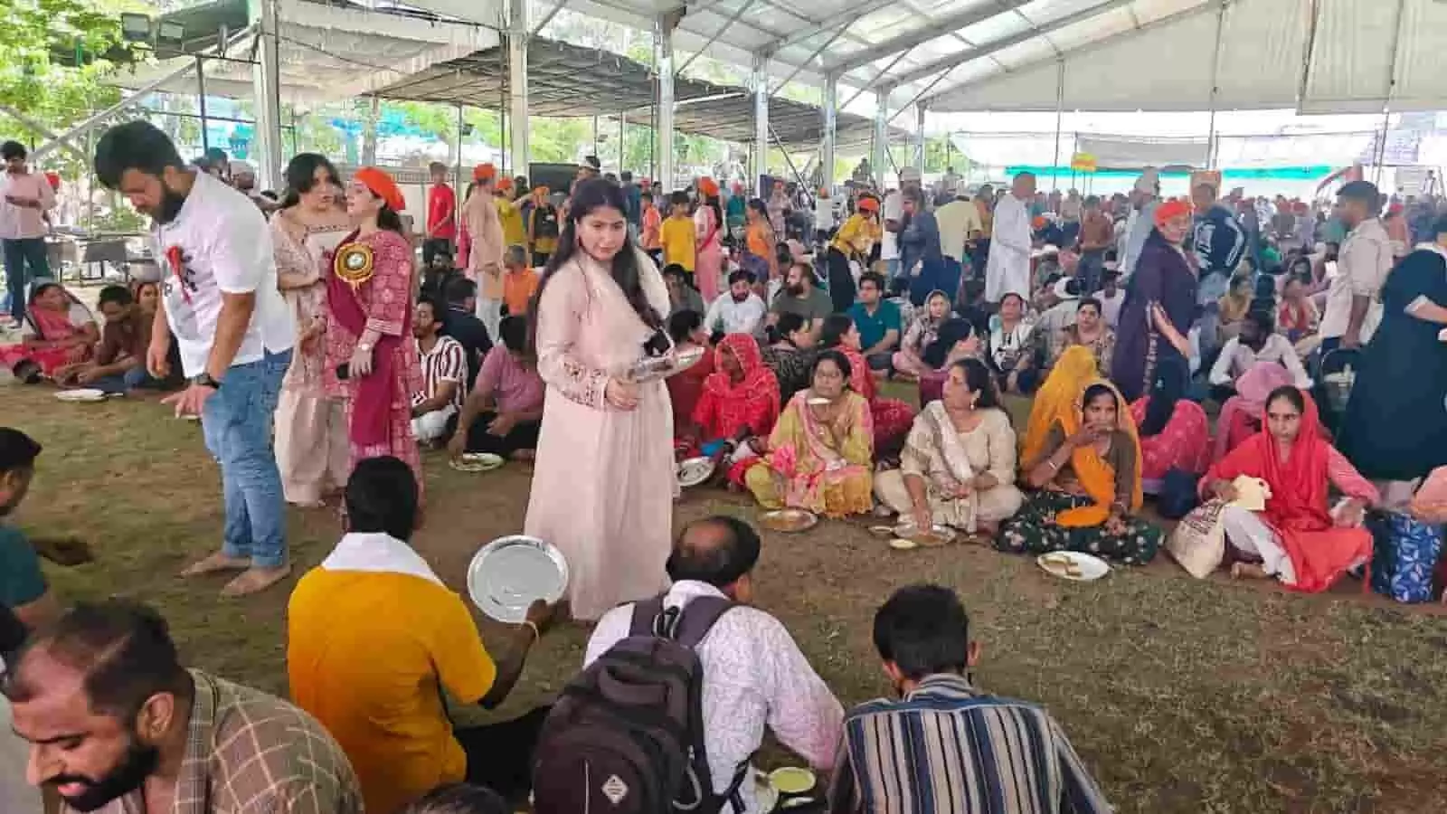 जयपुर के स्वामी गंगादास महाराज मंदिर भंडारे में जमीन पर बैठकर भोजन करते श्रद्धालु और सेवा करते सेवादार।
