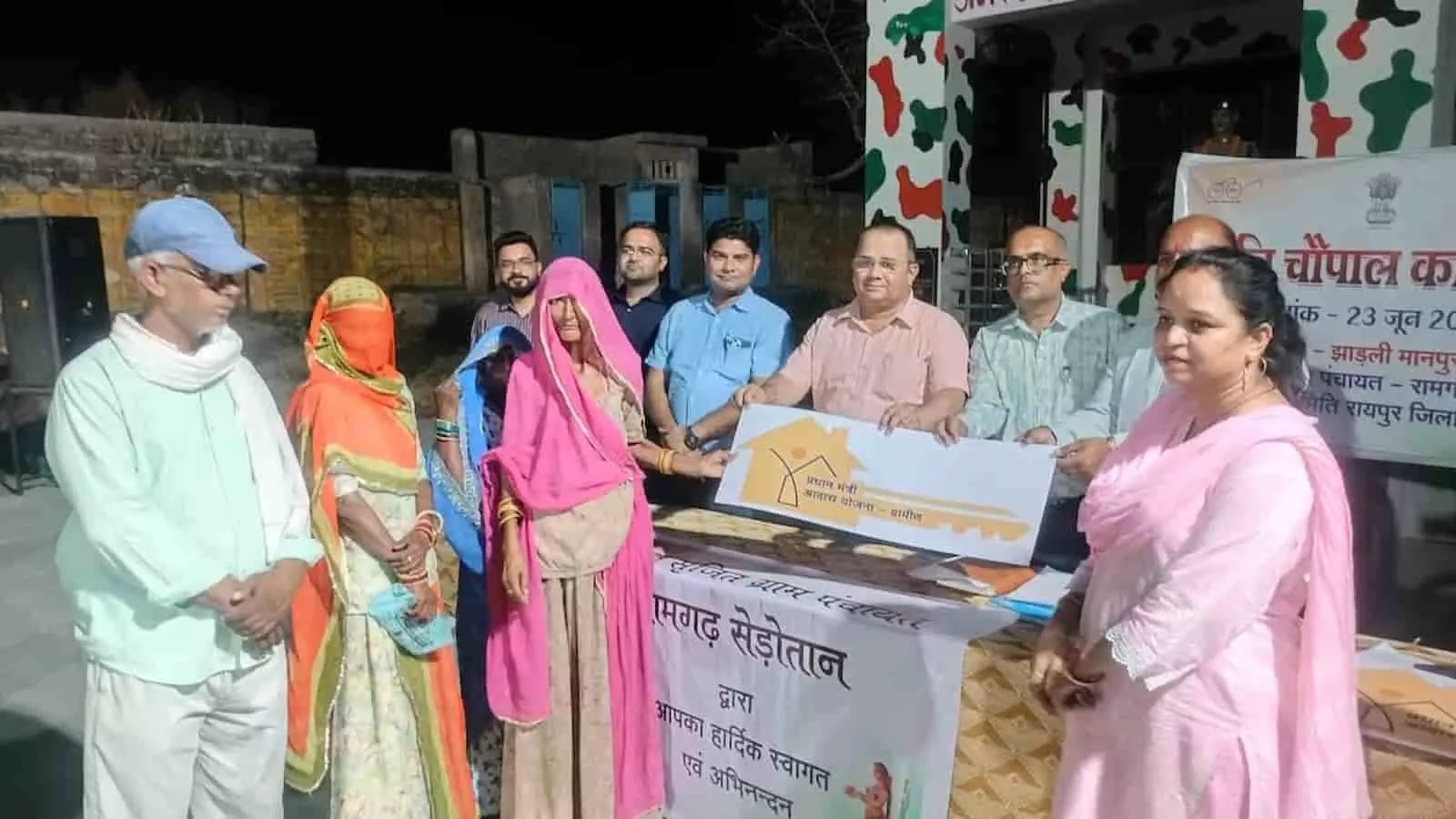 झाड़ली मानपुरा में आयोजित रात्रि चौपाल में ग्रामीणों को प्रधानमंत्री आवास योजना के तहत नए मकानों की चाबियां सौंपते जिला कलेक्टर और प्रशासनिक अधिकारी।