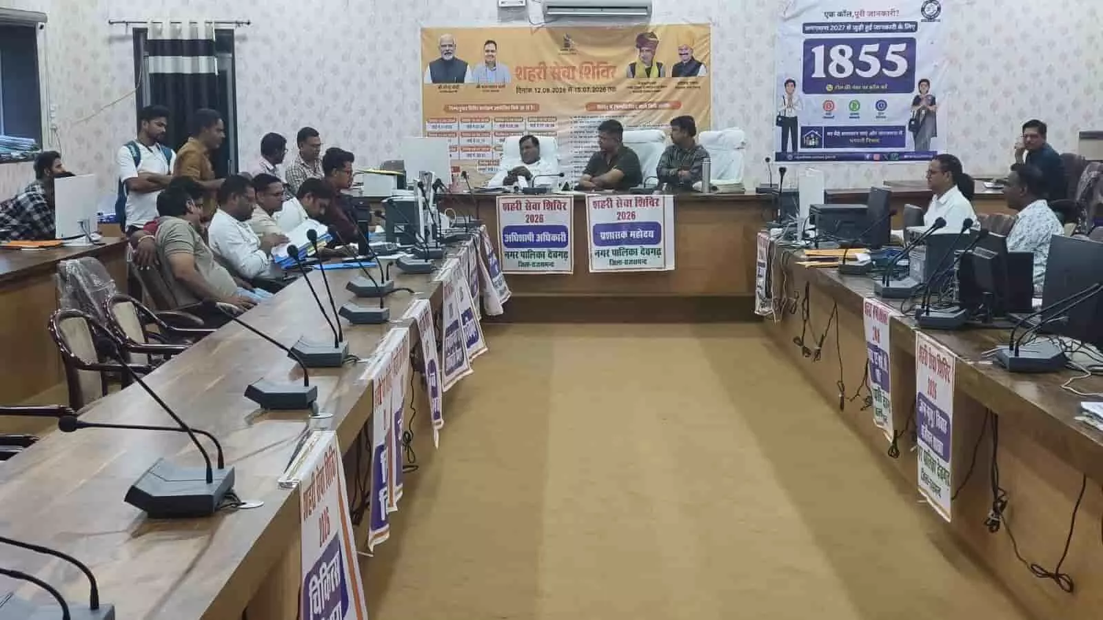 देवगढ़ नगर पालिका सभागार में मेज पर बैठे अधिकारियों का दृश्य शहरी सेवा शिविर के दौरान। देवगढ़ नगर पालिका सभागार में मेज पर बैठे अधिकारियों का दृश्य शहरी सेवा शिविर के दौरान।