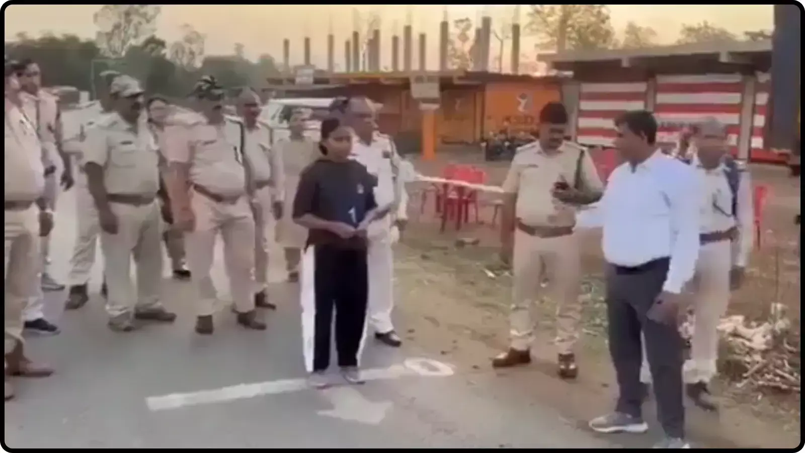 वर्दीधारी वन अधिकारियों के बीच खड़ी महिला अभ्यर्थी मध्य प्रदेश में शारीरिक दक्षता परीक्षा के संदर्भ में।