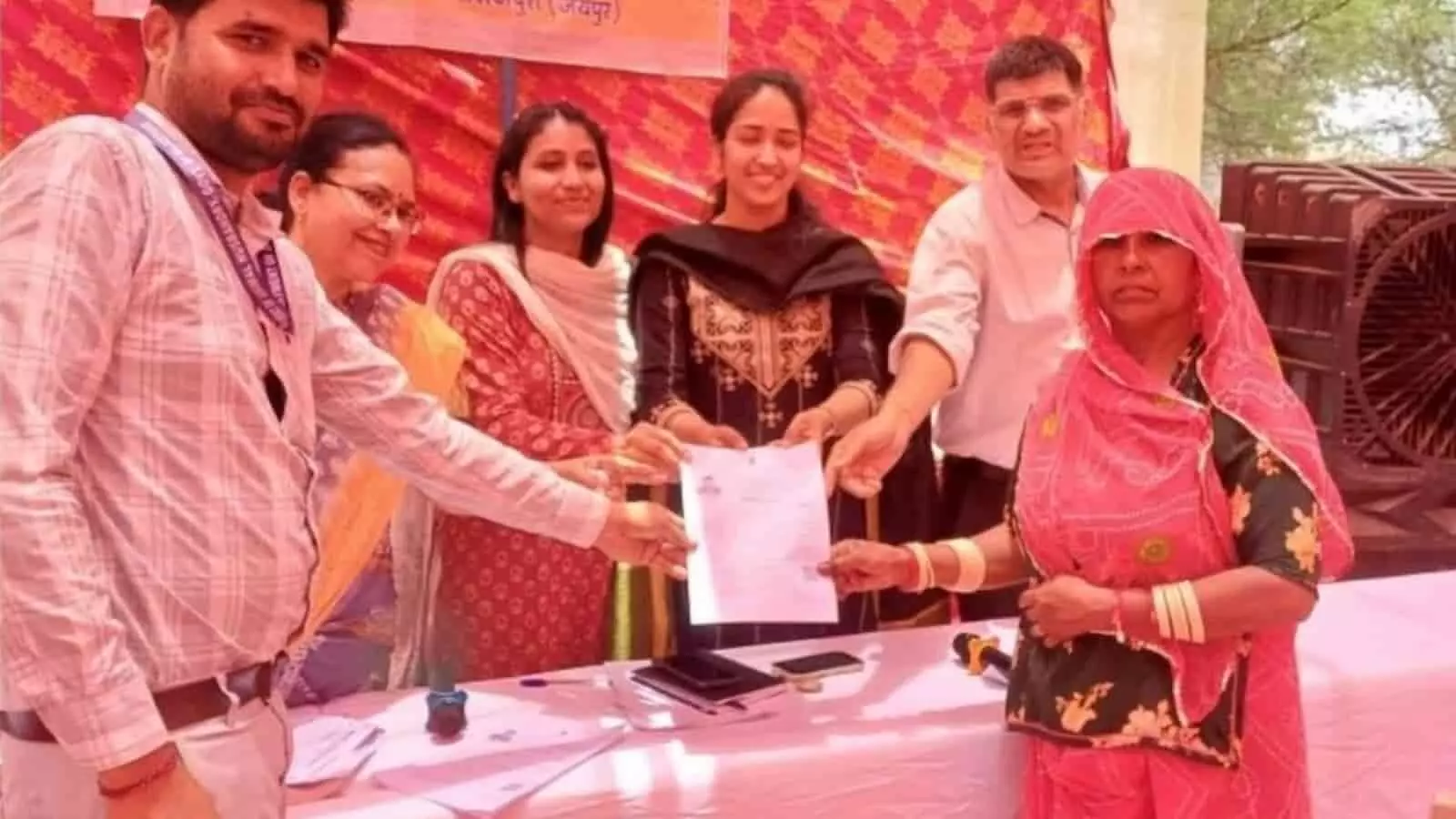 तस्वीर में सरकारी अधिकारी ग्रामीण सेवा शिविर में एक महिला को पशु बीमा पॉलिसी का दस्तावेज सौंप रहे हैं। तस्वीर में सरकारी अधिकारी ग्रामीण सेवा शिविर में एक महिला को पशु बीमा पॉलिसी का दस्तावेज सौंप रहे हैं।