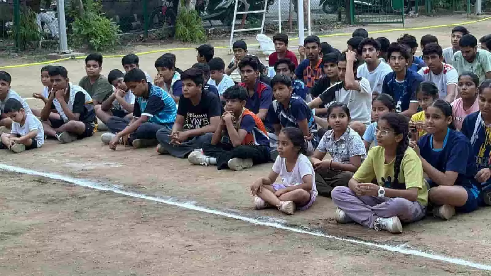 मैदान पर बैठे युवा खिलाड़ी चित्तौड़गढ़ में आयोजित वॉलीबॉल प्रशिक्षण शिविर के दौरान।
