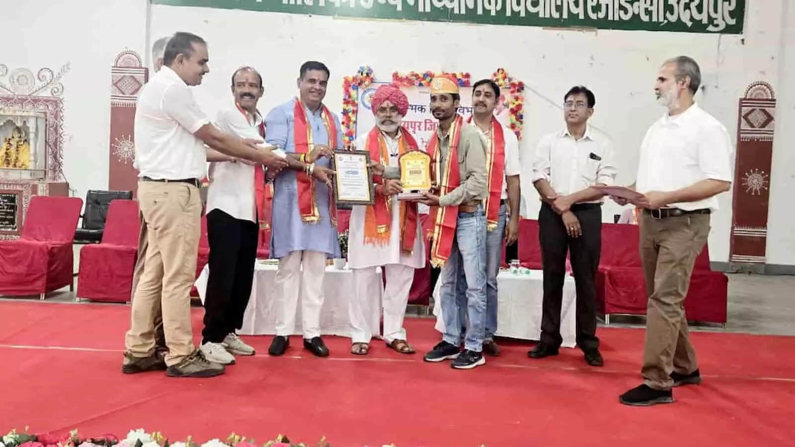 तस्वीर में उदयपुर के एक स्कूल में आयोजित समारोह के दौरान मंच पर शिक्षक नरेश कुमार लोहार को पुरस्कार प्रदान करते अतिथि दिख रहे हैं।