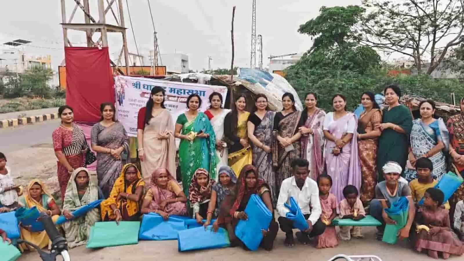 तस्वीर में धाकड़ महासभा की सदस्य झुग्गी-झोपड़ी में जरूरतमंद परिवारों को नीली तिरपाल बांटते हुए।