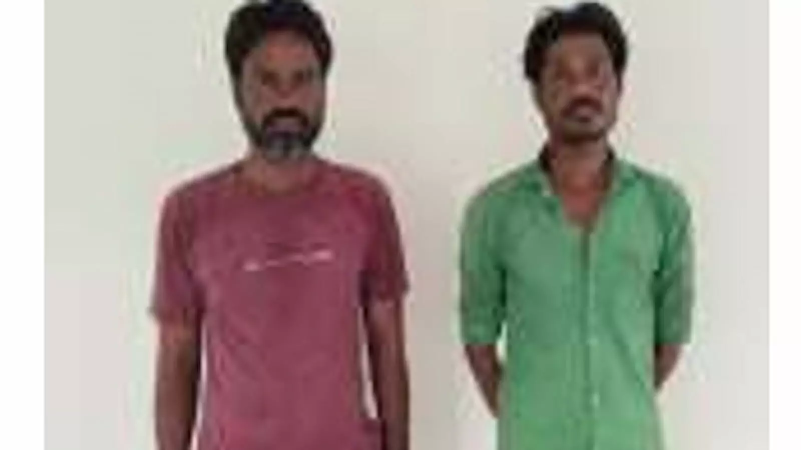 तस्वीर में पुलिस हिरासत में खड़े दो आरोपी व्यक्ति सफेद दीवार के सामने दिखाई दे रहे हैं। तस्वीर में पुलिस हिरासत में खड़े दो आरोपी व्यक्ति सफेद दीवार के सामने दिखाई दे रहे हैं।