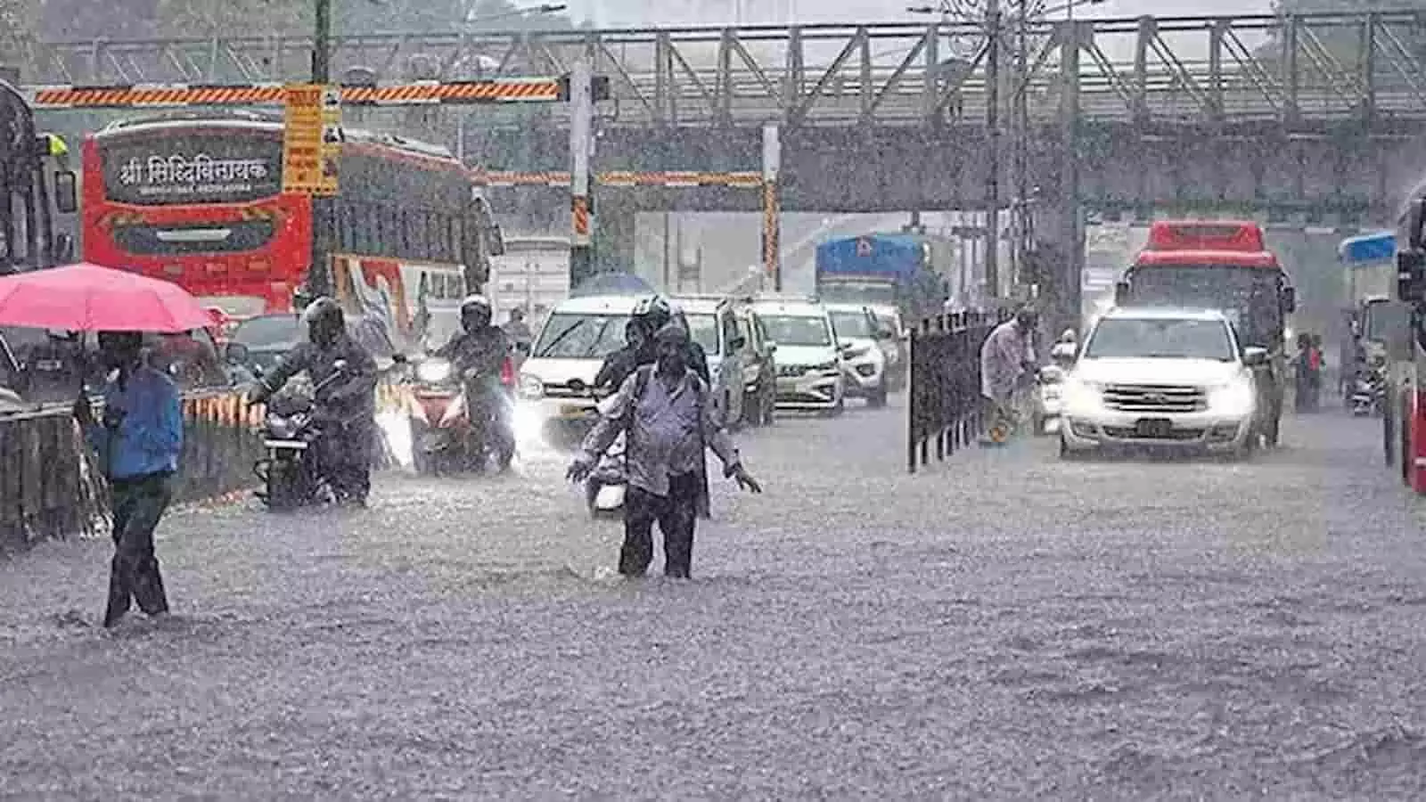मुंबई की बारिश के दौरान जलमग्न सड़क पर चलते लोग और वाहन दिखाई दे रहे हैं। मुंबई की बारिश के दौरान जलमग्न सड़क पर चलते लोग और वाहन दिखाई दे रहे हैं।