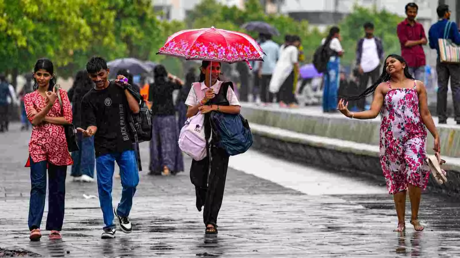 बारिश के दौरान दिल्ली की सड़कों पर छाता लेकर चलते हुए लोग। बारिश के दौरान दिल्ली की सड़कों पर छाता लेकर चलते हुए लोग।