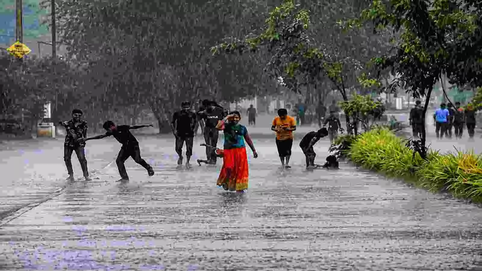 बारिश में सड़क पर चल रहे लोग, उत्तर भारत में भारी मानसून के संदर्भ में। बारिश में सड़क पर चल रहे लोग, उत्तर भारत में भारी मानसून के संदर्भ में।