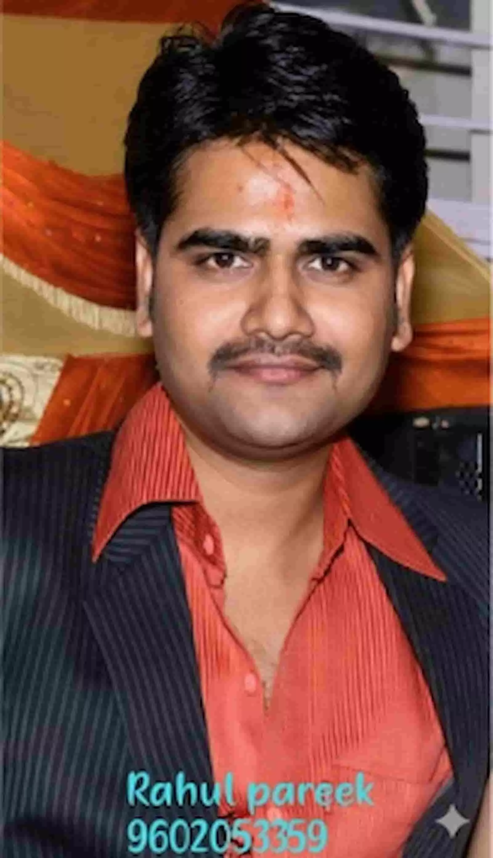 तस्वीर में कोट और नारंगी शर्ट पहने मुस्कुराते हुए राहुल पारीक दिख रहे हैं। तस्वीर में कोट और नारंगी शर्ट पहने मुस्कुराते हुए राहुल पारीक दिख रहे हैं।