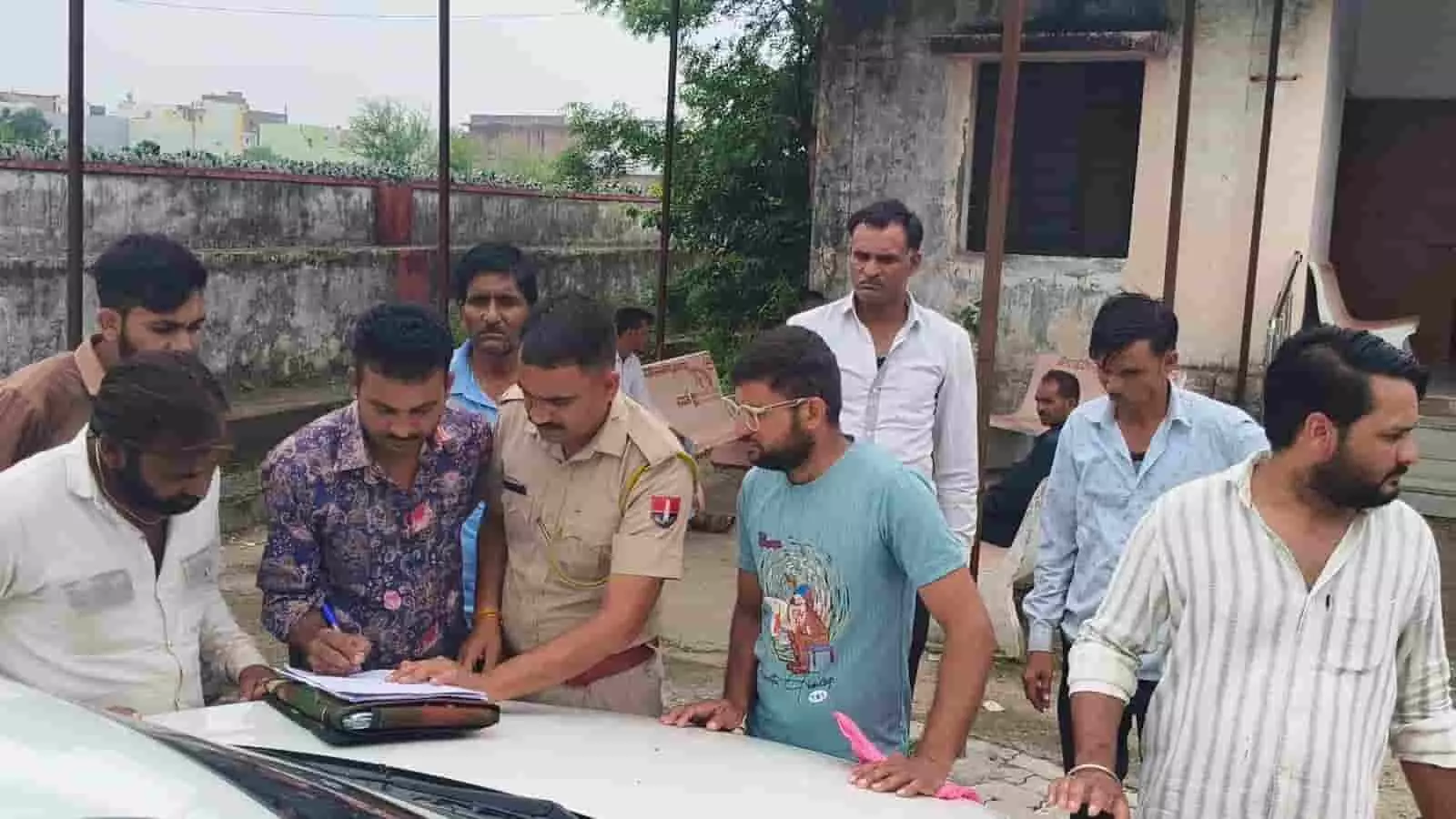 तस्वीर में पुलिस अधिकारी और ग्रामीण एक वाहन के पास खड़े होकर कानूनी दस्तावेज तैयार कर रहे हैं। तस्वीर में पुलिस अधिकारी और ग्रामीण एक वाहन के पास खड़े होकर कानूनी दस्तावेज तैयार कर रहे हैं।