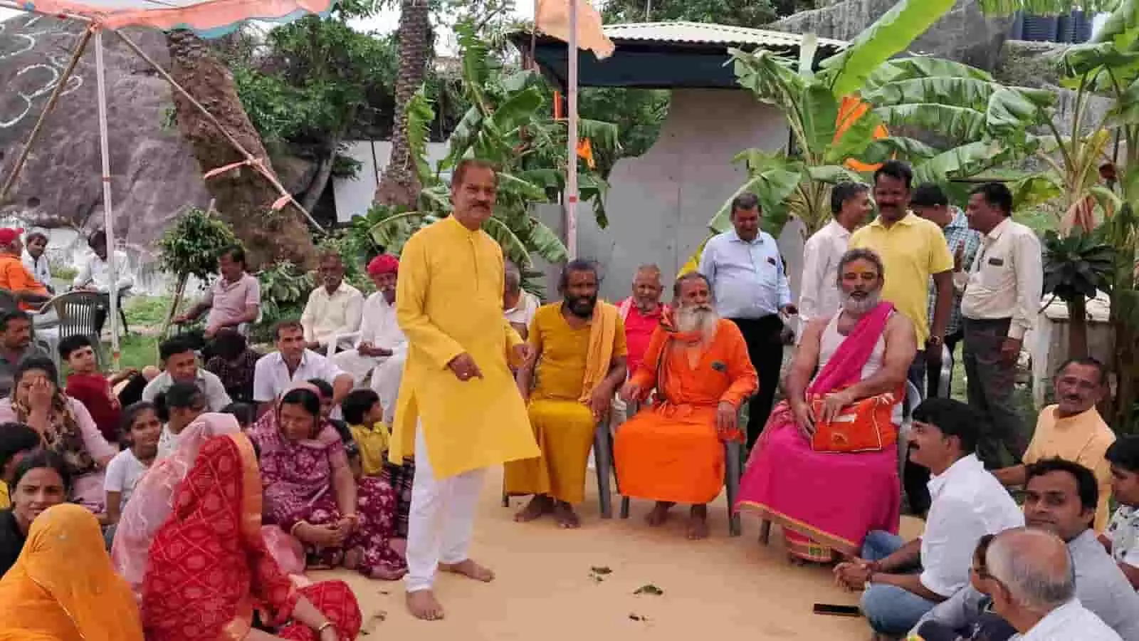 आश्रम परिसर में बैठे साधु-संत और उपस्थित श्रद्धालु एक धार्मिक कार्यक्रम के दौरान। आश्रम परिसर में बैठे साधु-संत और उपस्थित श्रद्धालु एक धार्मिक कार्यक्रम के दौरान।