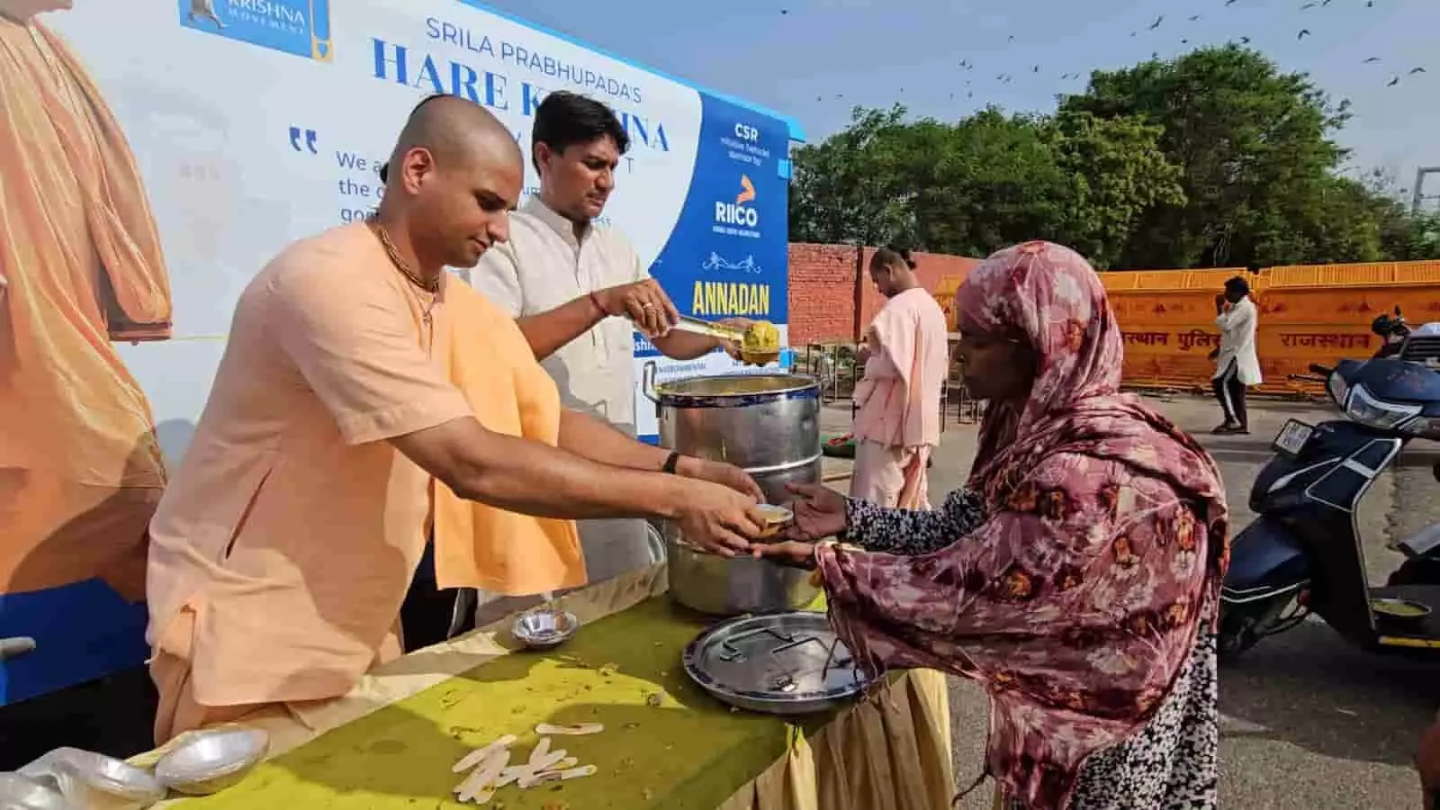 जयपुर में हरे कृष्ण मूवमेंट के सदस्य एक महिला को खिचड़ी वितरित कर रहे हैं।