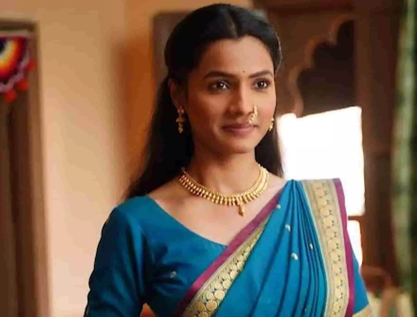नीले रंग की साड़ी पहने अभिनेत्री आरती बिराजदार सेट पर खड़ी हैं। नीले रंग की साड़ी पहने अभिनेत्री आरती बिराजदार सेट पर खड़ी हैं।
