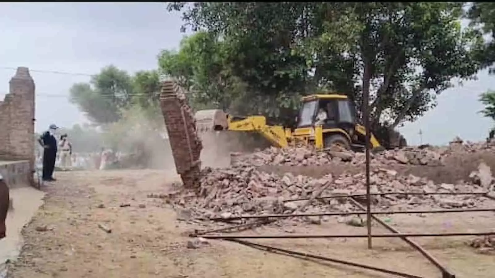 डीग के सीकरी में अवैध निर्माण को गिराता हुआ पीला बुलडोजर दिखाई दे रहा है। डीग के सीकरी में अवैध निर्माण को गिराता हुआ पीला बुलडोजर दिखाई दे रहा है।