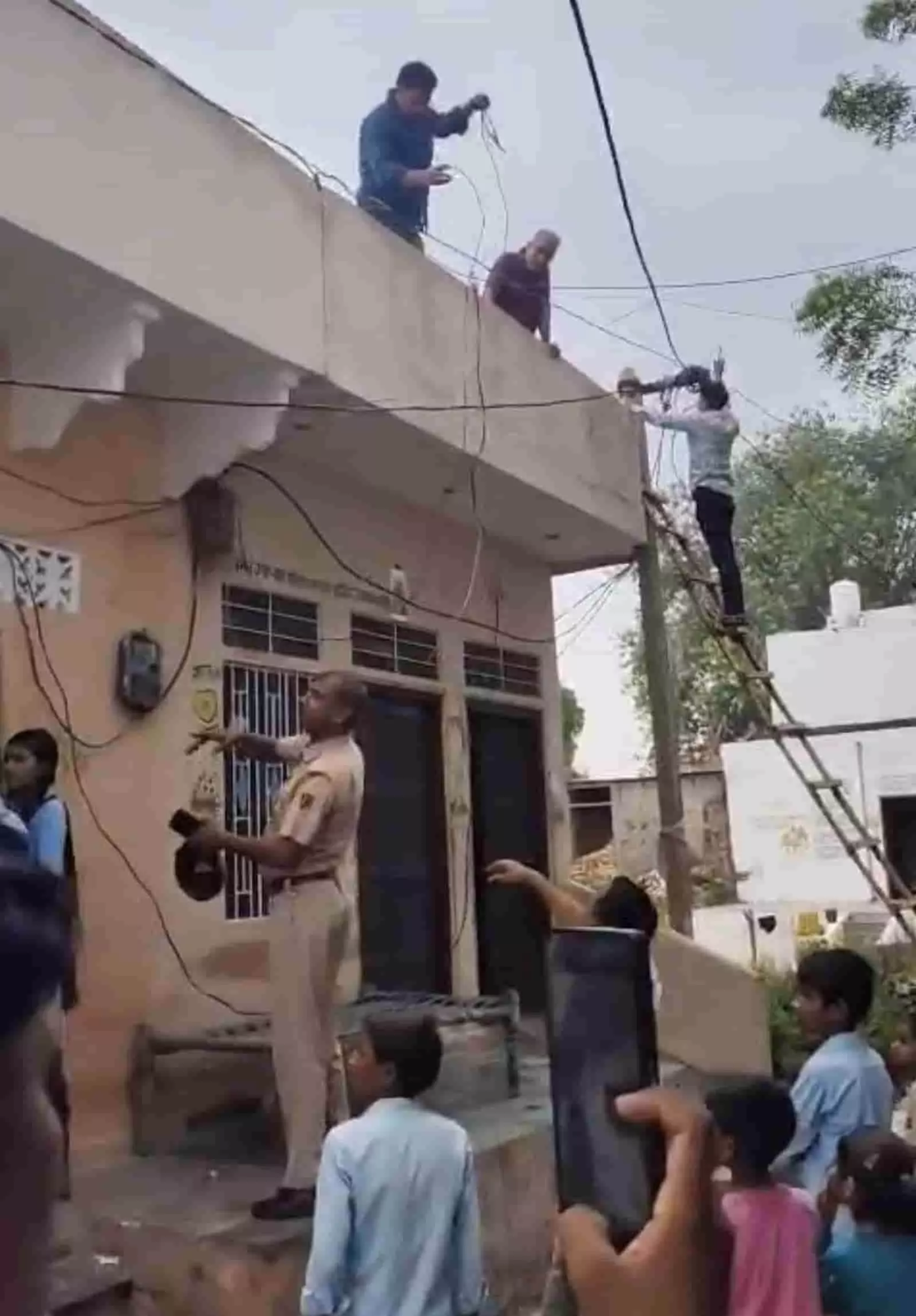 तस्वीर में सवाई माधोपुर में बिजली विभाग की टीम और पुलिसकर्मी मकान से अवैध विद्युत कनेक्शन काटते हुए दिख रहे हैं। तस्वीर में सवाई माधोपुर में बिजली विभाग की टीम और पुलिसकर्मी मकान से अवैध विद्युत कनेक्शन काटते हुए दिख रहे हैं।