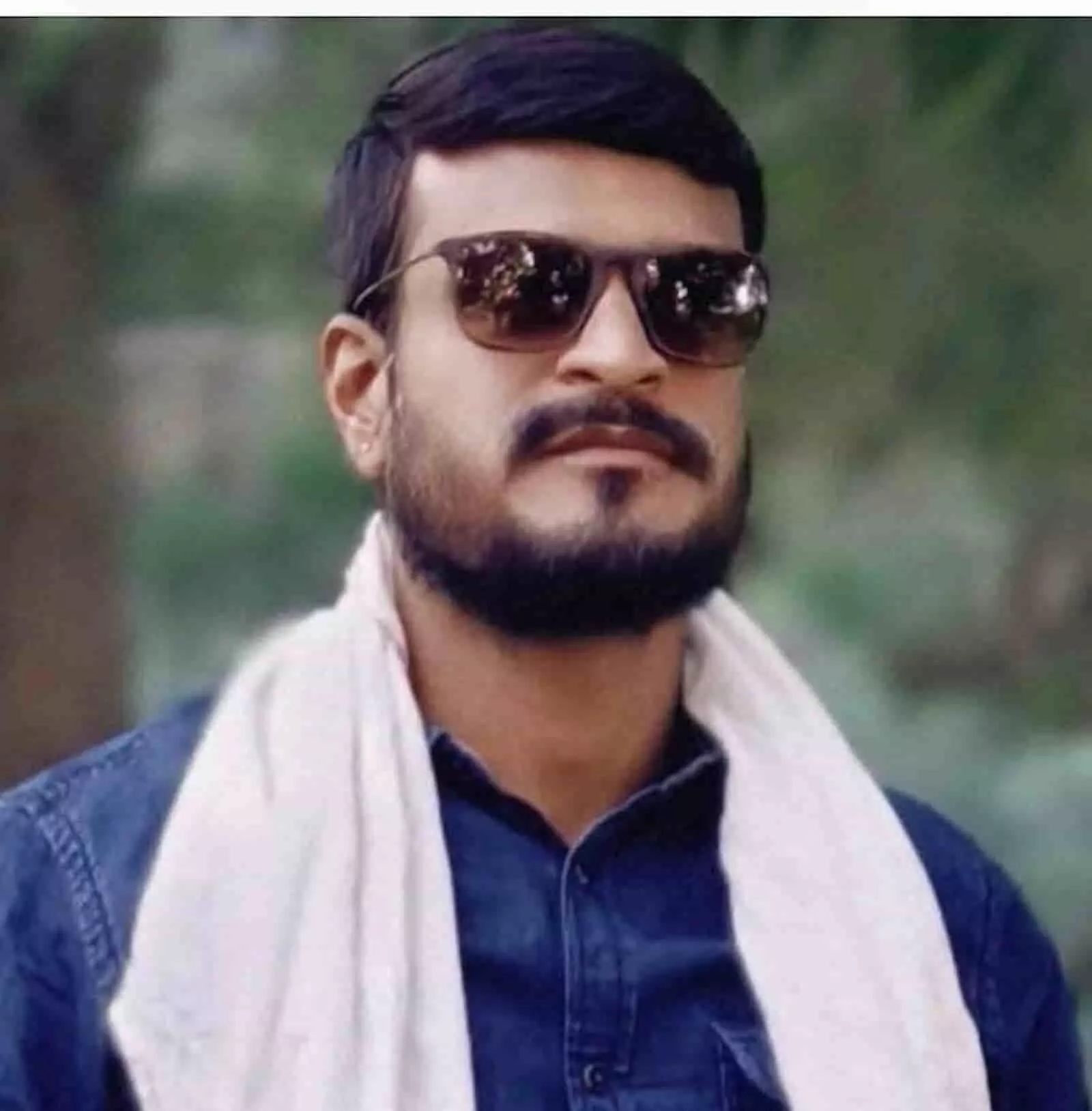 तस्वीर में चश्मा लगाए और गले में गमछा डाले टीनसा धींग की तस्वीर। तस्वीर में चश्मा लगाए और गले में गमछा डाले टीनसा धींग की तस्वीर।