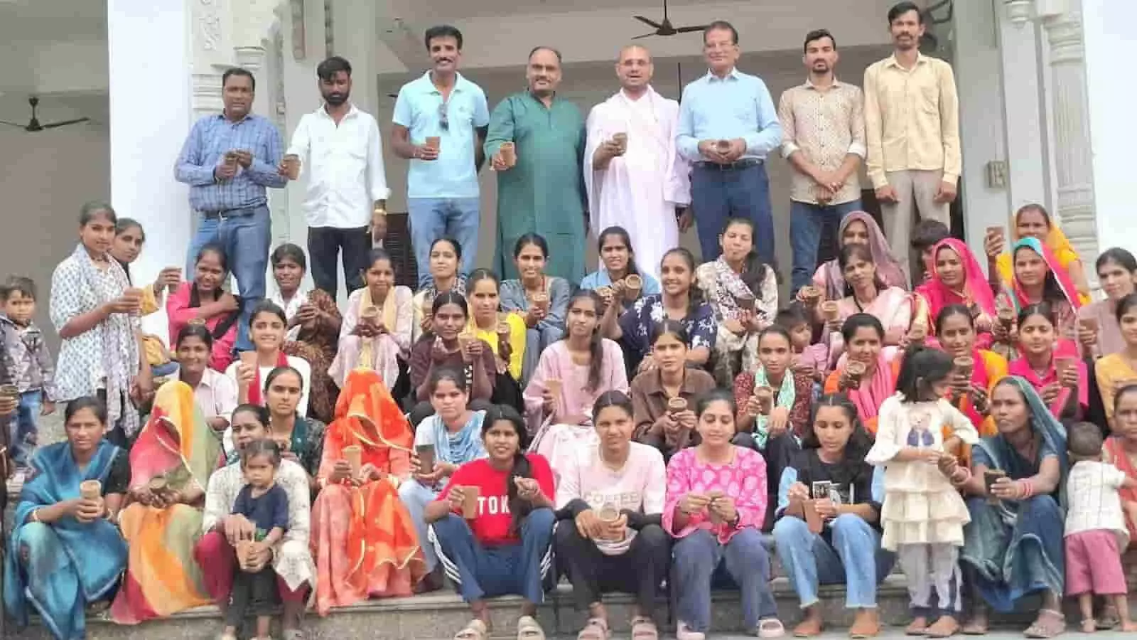 तस्वीर में सीढ़ियों पर बैठे लोग मिट्टी के पात्र हाथ में लिए हुए दिखाई दे रहे हैं। तस्वीर में सीढ़ियों पर बैठे लोग मिट्टी के पात्र हाथ में लिए हुए दिखाई दे रहे हैं।