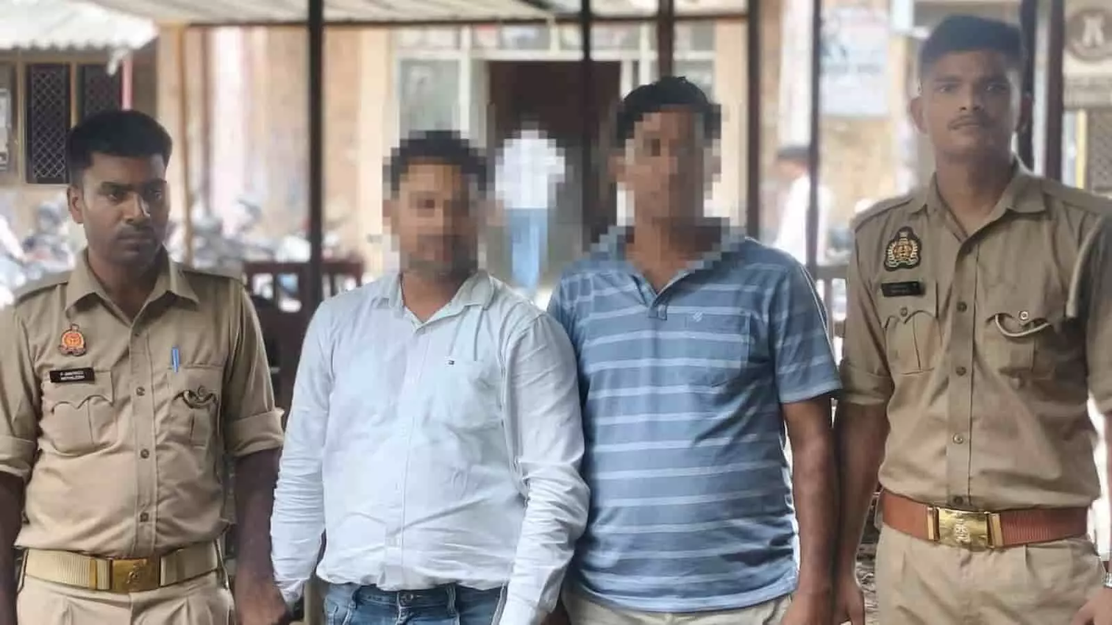 मुगलसराय थाना परिसर में पुलिसकर्मियों की कस्टडी में खड़े दो आरोपी।
