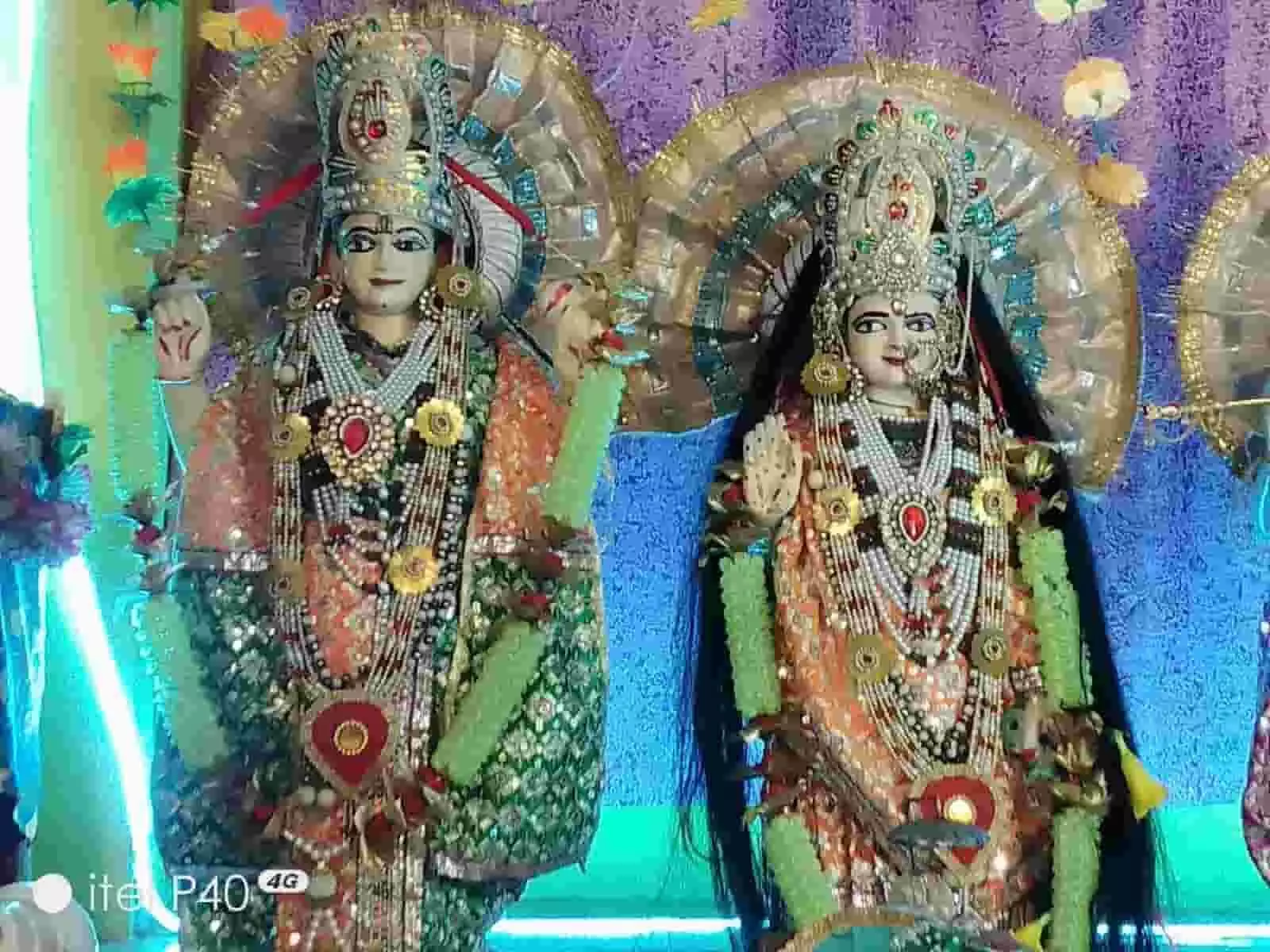 तस्वीर में मंदिर में सुंदर वस्त्रों और आभूषणों से सजी भगवान विष्णु और देवी लक्ष्मी की मूर्तियां स्थापित हैं। तस्वीर में मंदिर में सुंदर वस्त्रों और आभूषणों से सजी भगवान विष्णु और देवी लक्ष्मी की मूर्तियां स्थापित हैं।