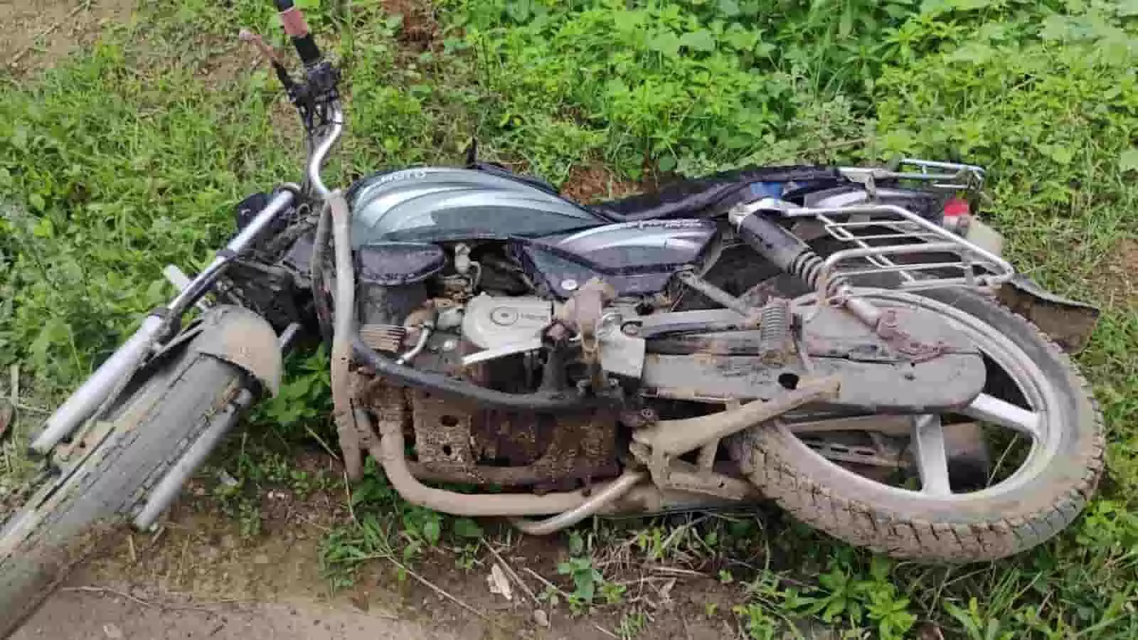 तस्वीर में सड़क किनारे घास पर दुर्घटनाग्रस्त पड़ी एक मोटरसाइकिल दिख रही है। तस्वीर में सड़क किनारे घास पर दुर्घटनाग्रस्त पड़ी एक मोटरसाइकिल दिख रही है।