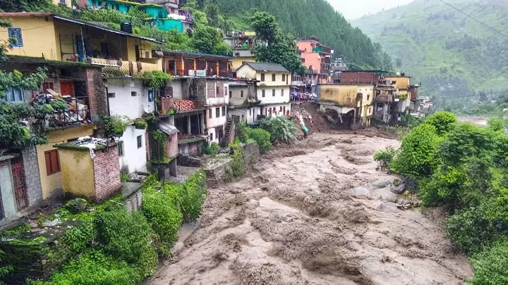 उफनता नाला और मकान पहाड़ी क्षेत्रों में हिमाचल प्रदेश और उत्तराखंड में भारी बारिश के खतरे को दर्शाते हैं। उफनता नाला और मकान पहाड़ी क्षेत्रों में हिमाचल प्रदेश और उत्तराखंड में भारी बारिश के खतरे को दर्शाते हैं।