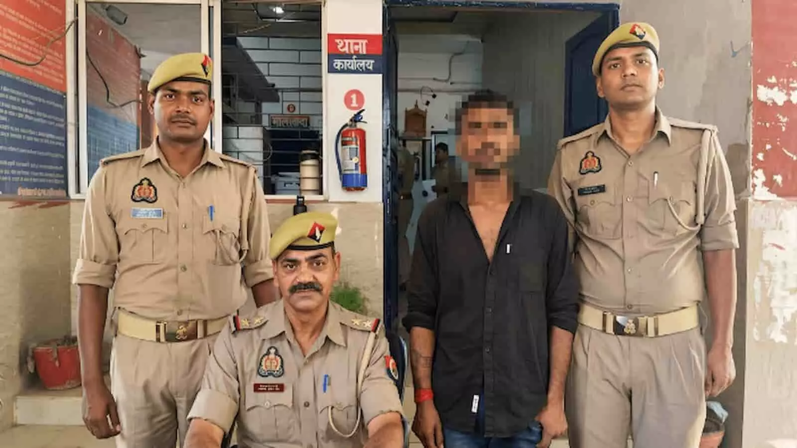 तस्वीर में पुलिस कर्मियों के साथ थाना परिसर में खड़ा गिरफ्तार आरोपी दिख रहा है। तस्वीर में पुलिस कर्मियों के साथ थाना परिसर में खड़ा गिरफ्तार आरोपी दिख रहा है।