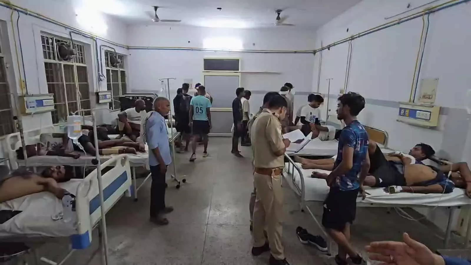 तस्वीर में अस्पताल वार्ड में घायल लोग बेड पर और पुलिसकर्मी दिख रहे हैं। तस्वीर में अस्पताल वार्ड में घायल लोग बेड पर और पुलिसकर्मी दिख रहे हैं।
