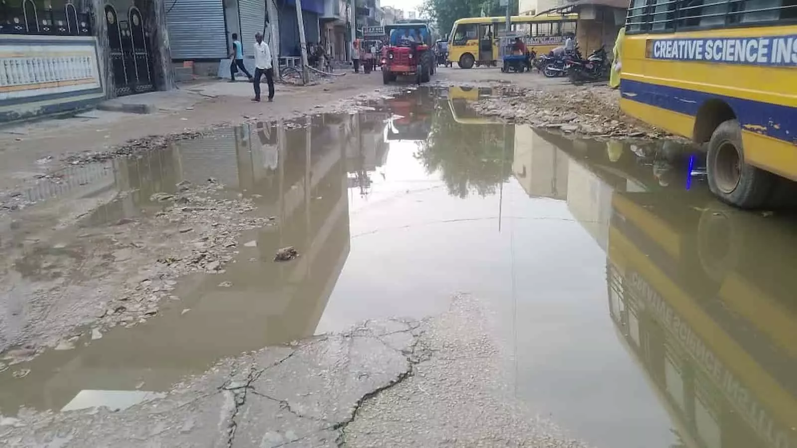 तस्वीर में गंगापुर-सिटी मार्ग पर जलभरावग्रस्त गड्ढों के बीच बसें और वाहन दिखते हैं। तस्वीर में गंगापुर-सिटी मार्ग पर जलभरावग्रस्त गड्ढों के बीच बसें और वाहन दिखते हैं।
