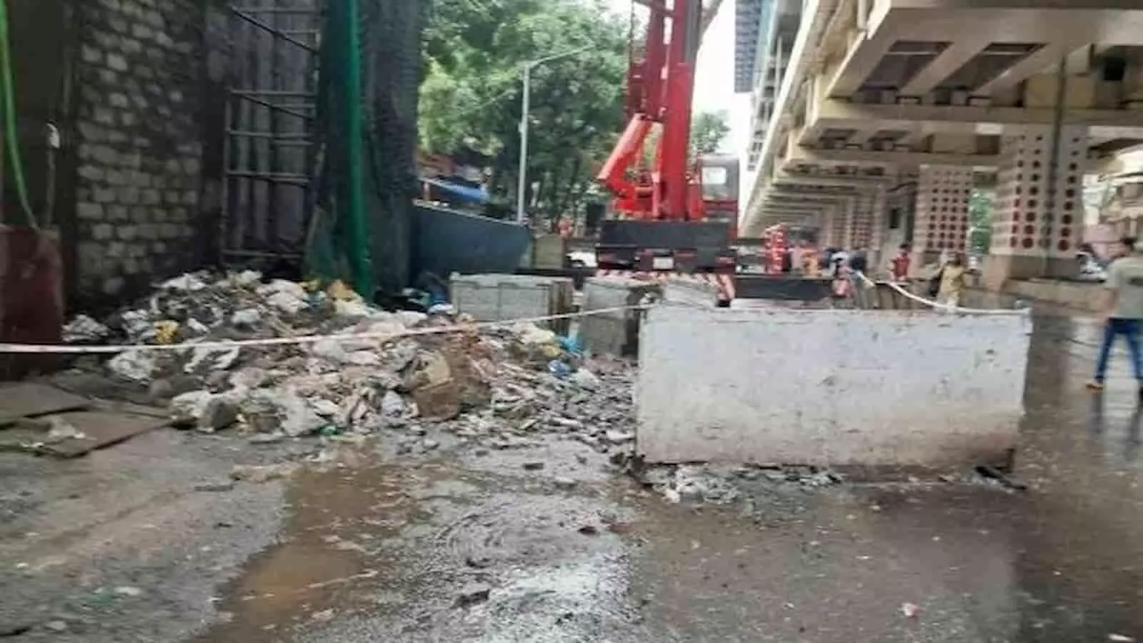 मीरा भयंदर में मेट्रो निर्माण स्थल पर सड़क पर बिखरा मलबा और खड़ी क्रेन दिख रही है। मीरा भयंदर में मेट्रो निर्माण स्थल पर सड़क पर बिखरा मलबा और खड़ी क्रेन दिख रही है।