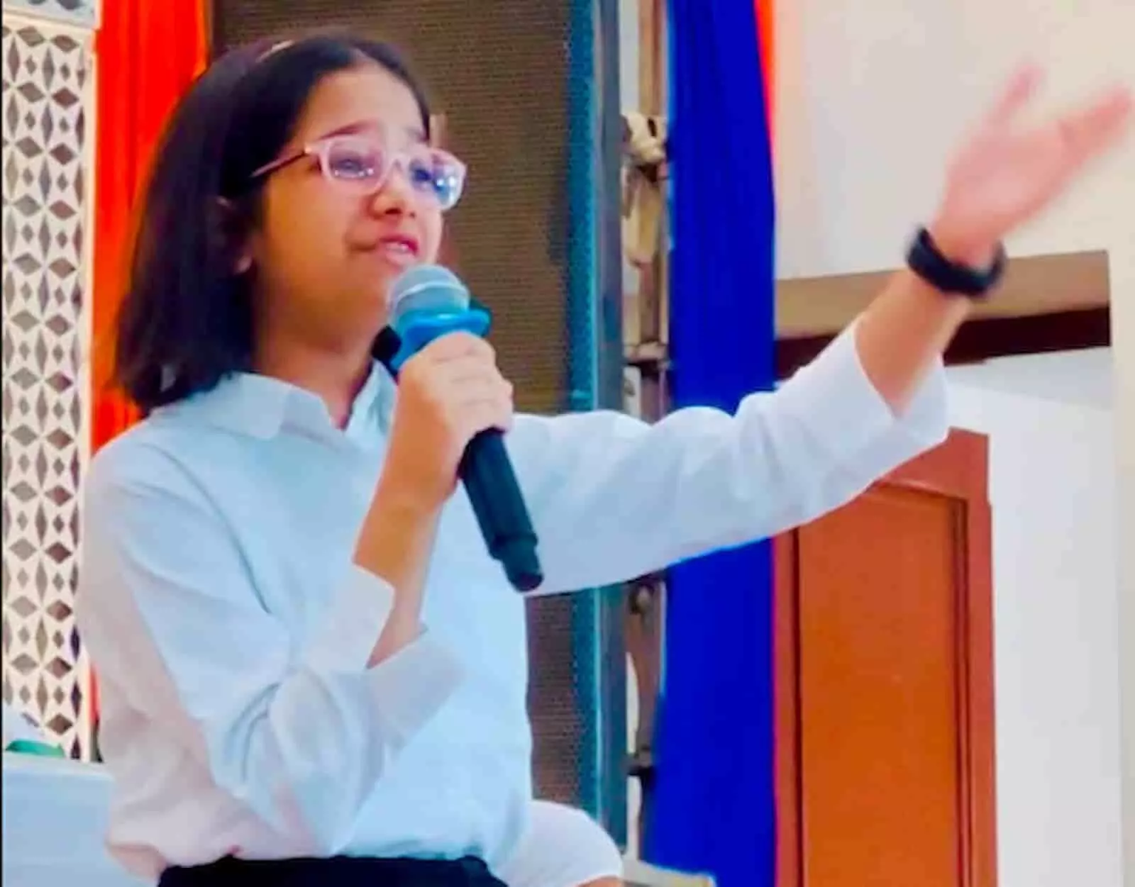 तस्वीर में मिती जैन सोगानी हॉल में माइक से संबोधित कर रही हैं। तस्वीर में मिती जैन सोगानी हॉल में माइक से संबोधित कर रही हैं।